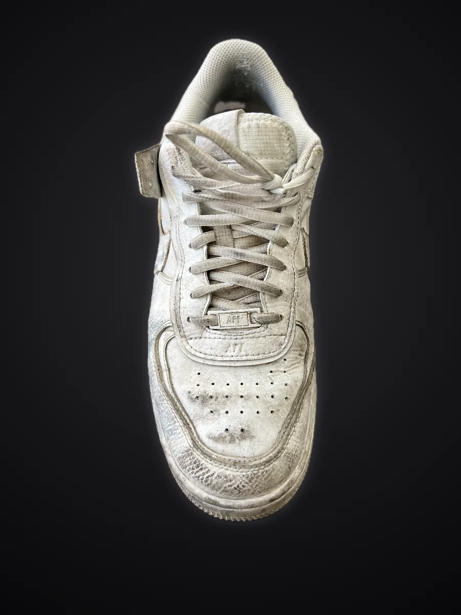 White sneaker before cleaning: grey and dirty