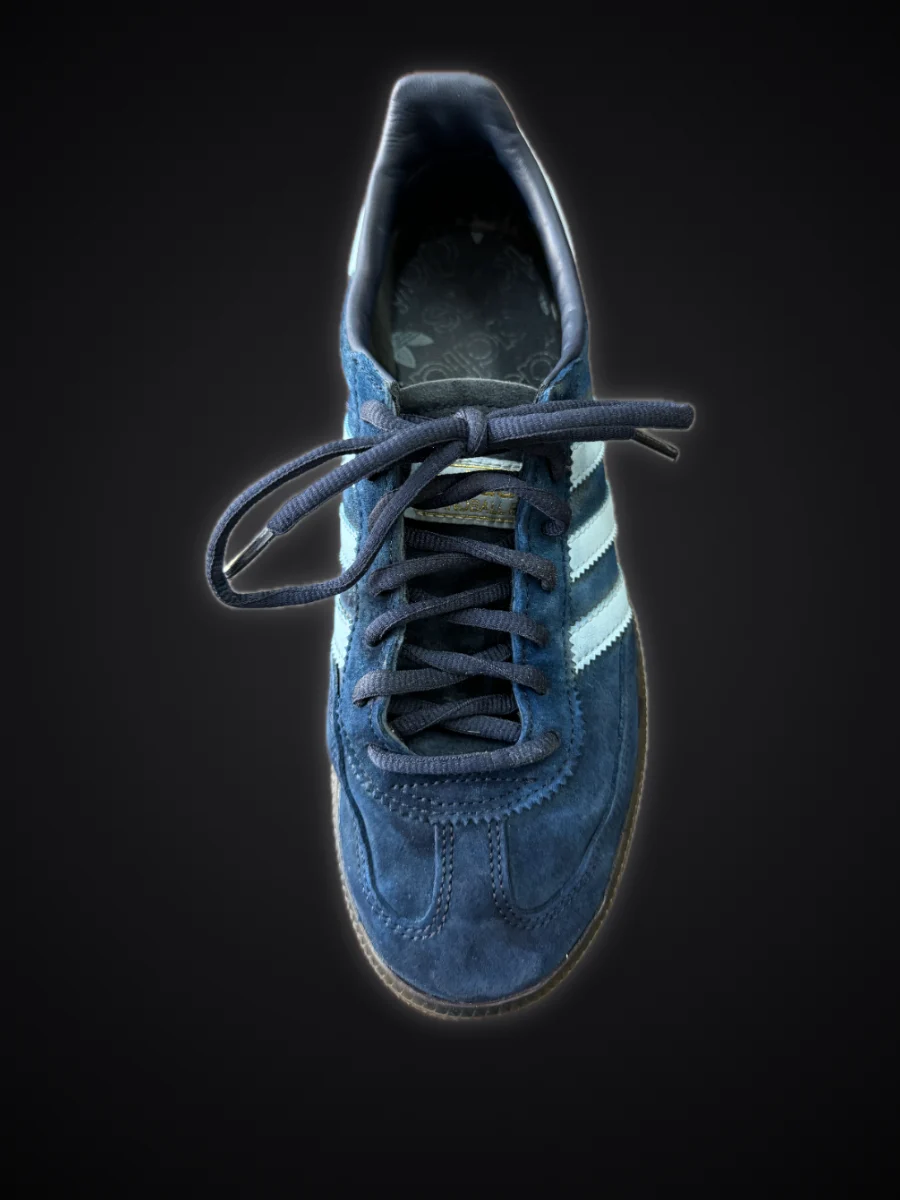 The same suede sneaker after cleaning: deep blue again